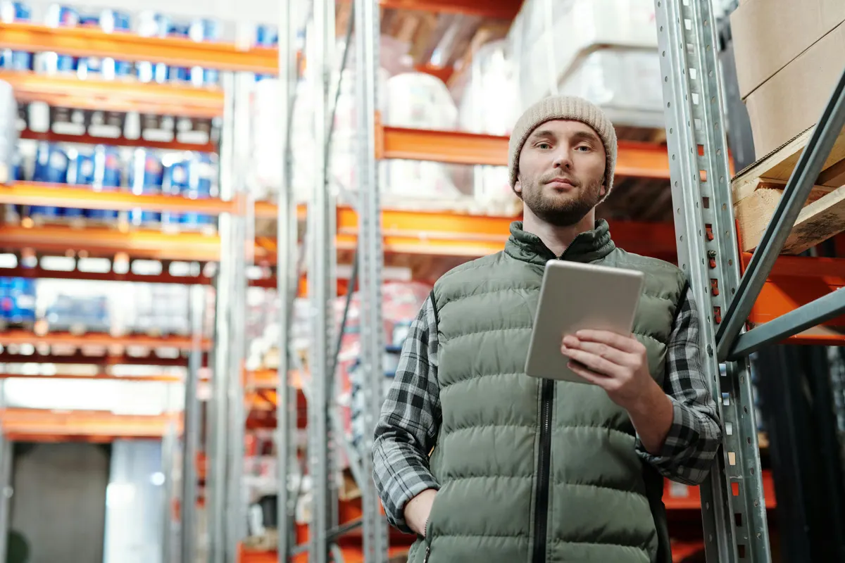 Trained warehouse supervisor with a tablet